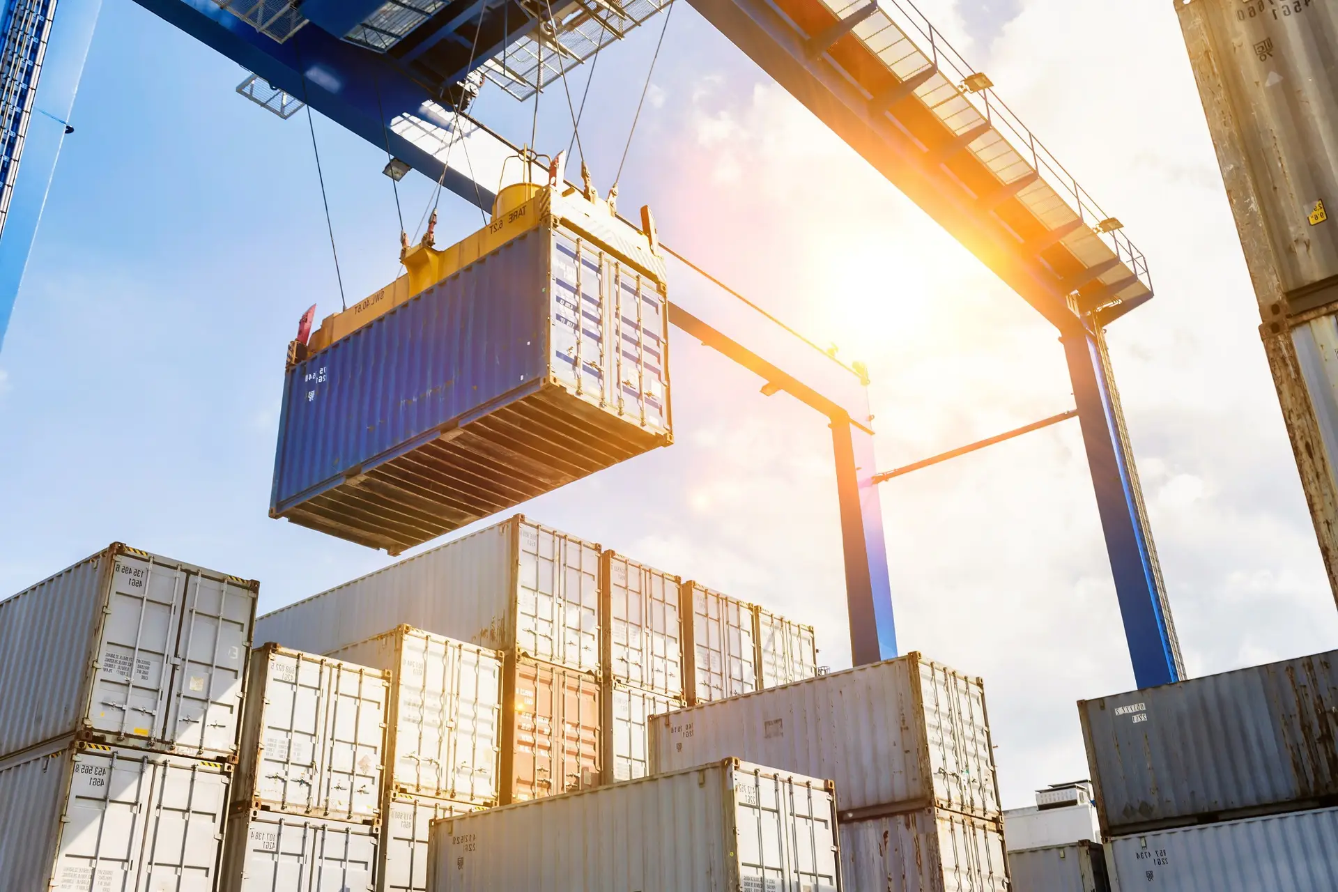 Crane lifting a dry cargo container at a container terminal