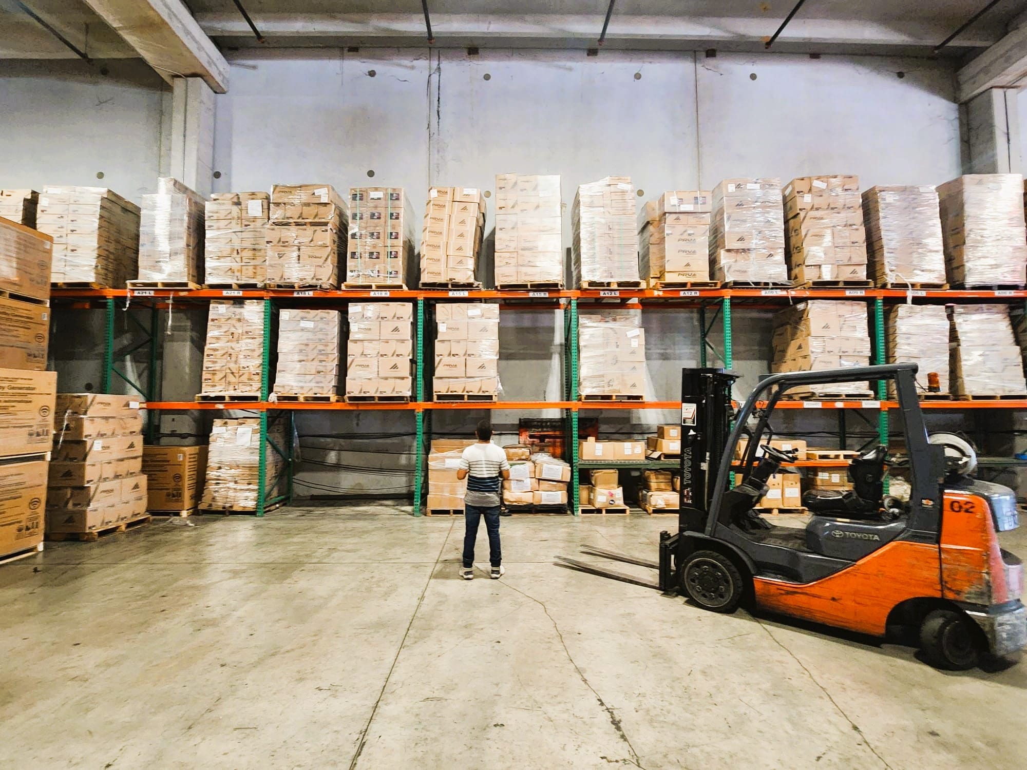 Forklift working between racked pallets inside the Express Freight International bonded warehouse in Medley, Miami
