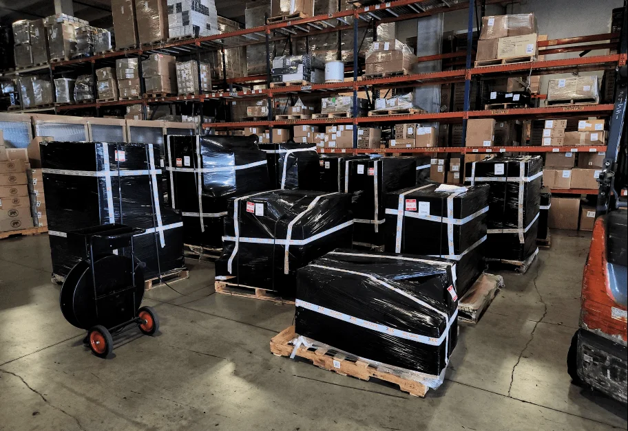 Road cases and equipment staged and wrapped on the warehouse floor at EFI, prepared for air freight