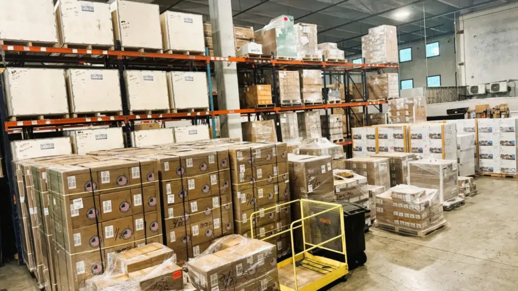 Stacked cartons and palletized freight staged for export consolidation