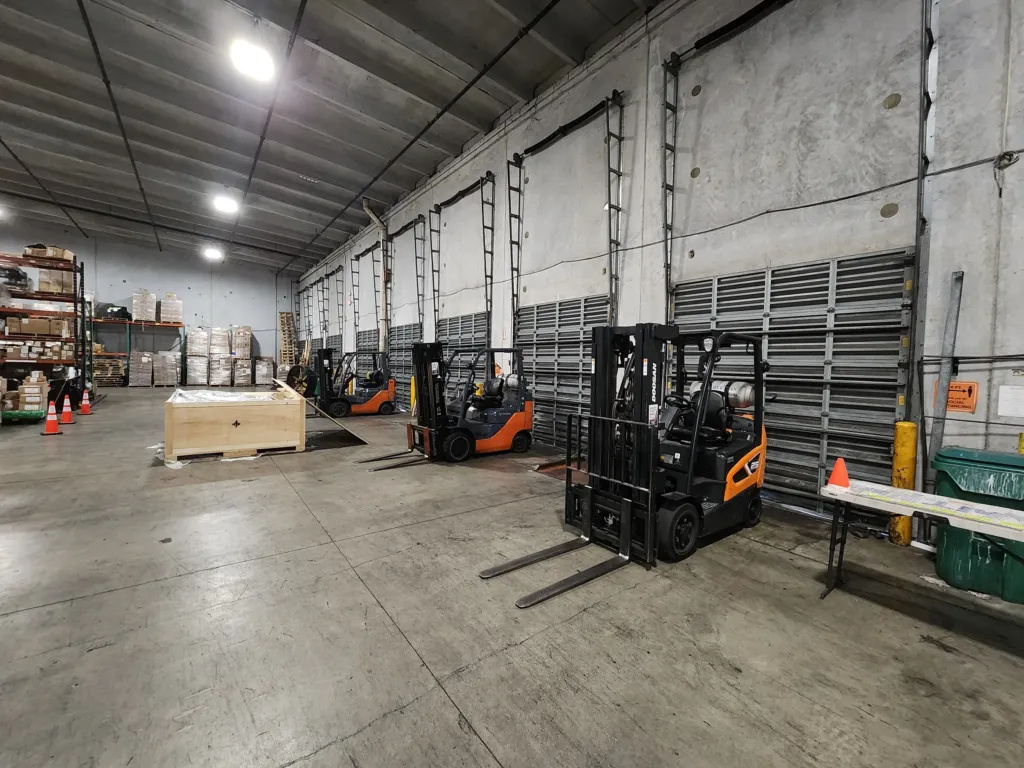 Forklifts staged at the dock doors inside the Express Freight International warehouse in Medley