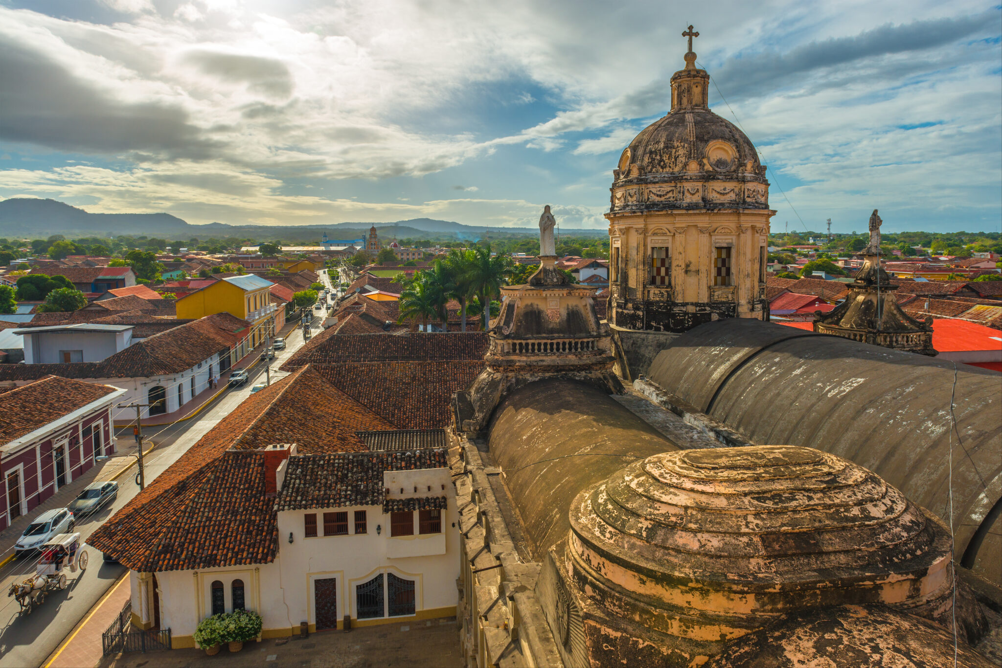 Red tile roofs and a colonial street in Granada, Nicaragua, seen from the roof of La Merced church
