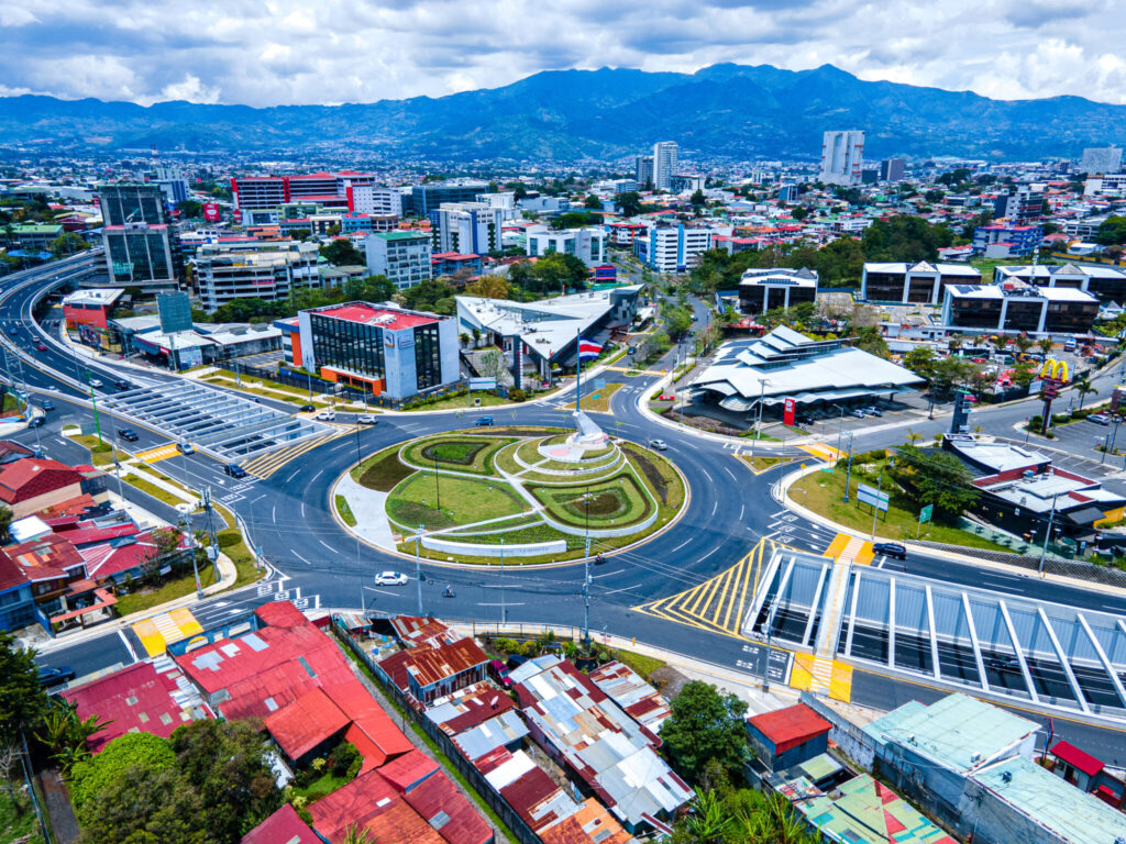 Aerial view of the Flag Roundabout in San José, Costa Rica, with the city and the Central Valley mountains behind
